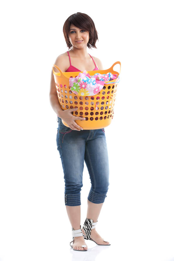woman holding a laundry basket against white background