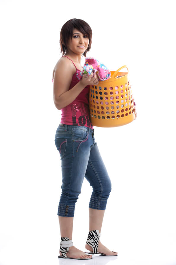 side view of a housewife holding a basket of clothes