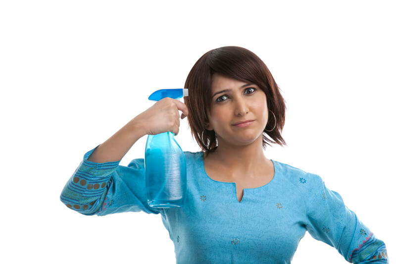housewife with a spray bottle over her head