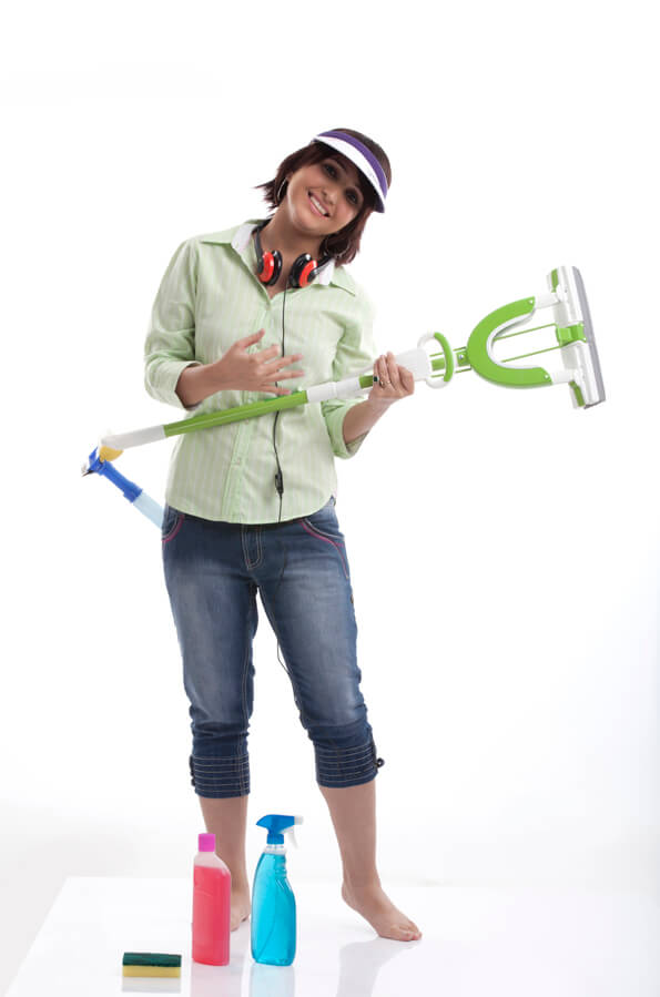 woman holding a cleaning mop as a guitar