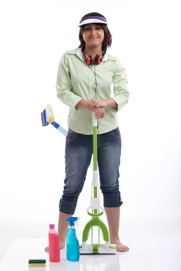 woman posing in casual clothing with cleaning products