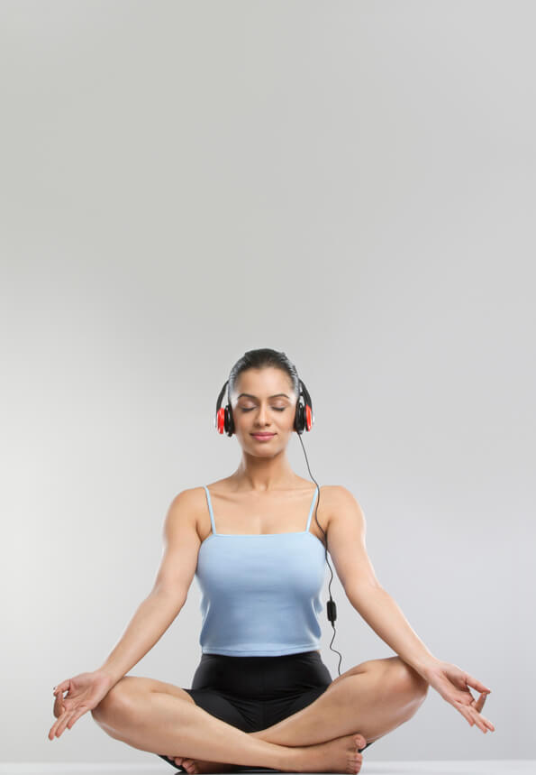 young girl performing meditation with headphone on 