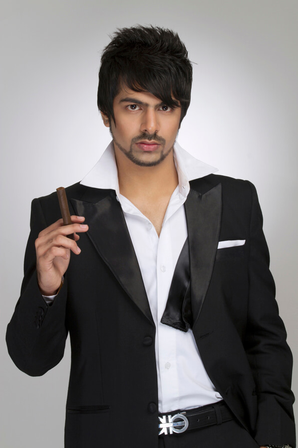 man in a tuxedo holding a cigar