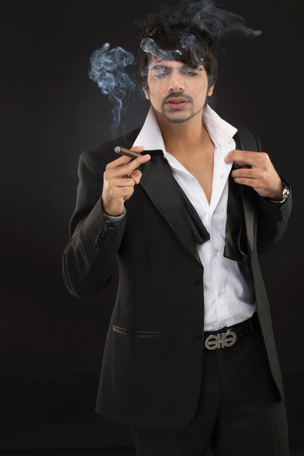 businessman in a tuxedo holding a cigar
