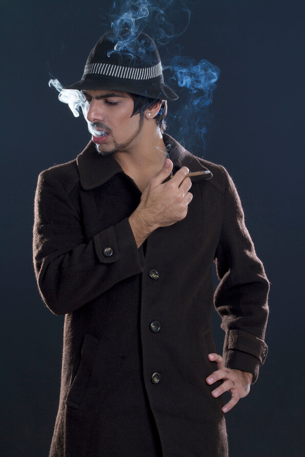 young man in overcoat smoking a cigar