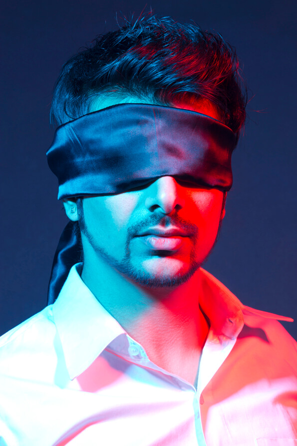 blindfolded man against dark background