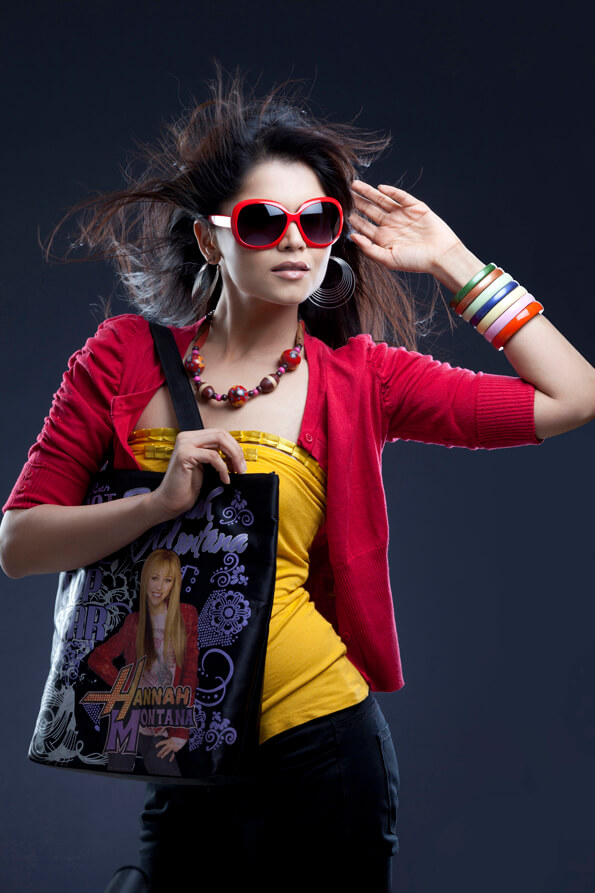 stylish young female carrying handbag and posing 
