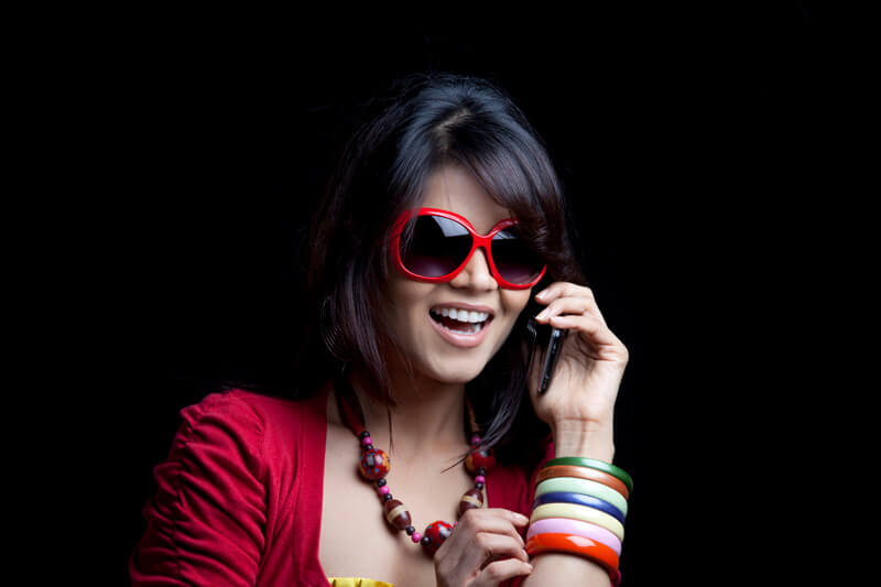 girl wearing shades talking on mobile phone