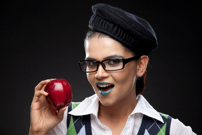 young woman posing with fresh red apple
