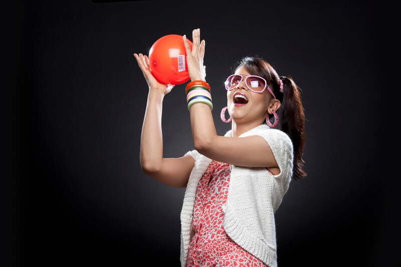trendy girl playing with red colour ball