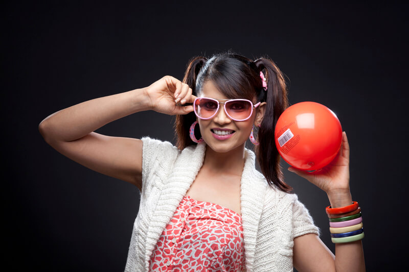 stylish woman posing with red ball with barcode