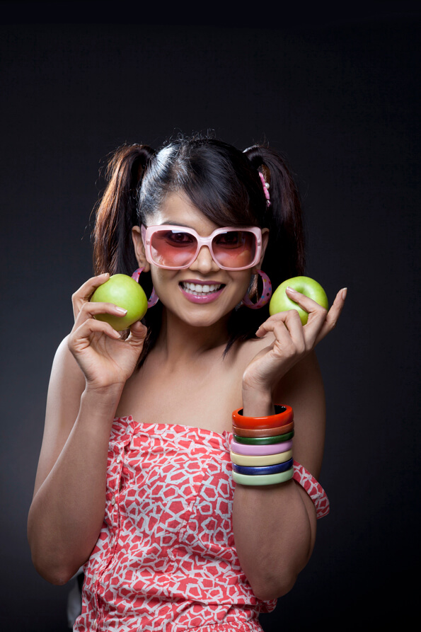 girl posing with green apples