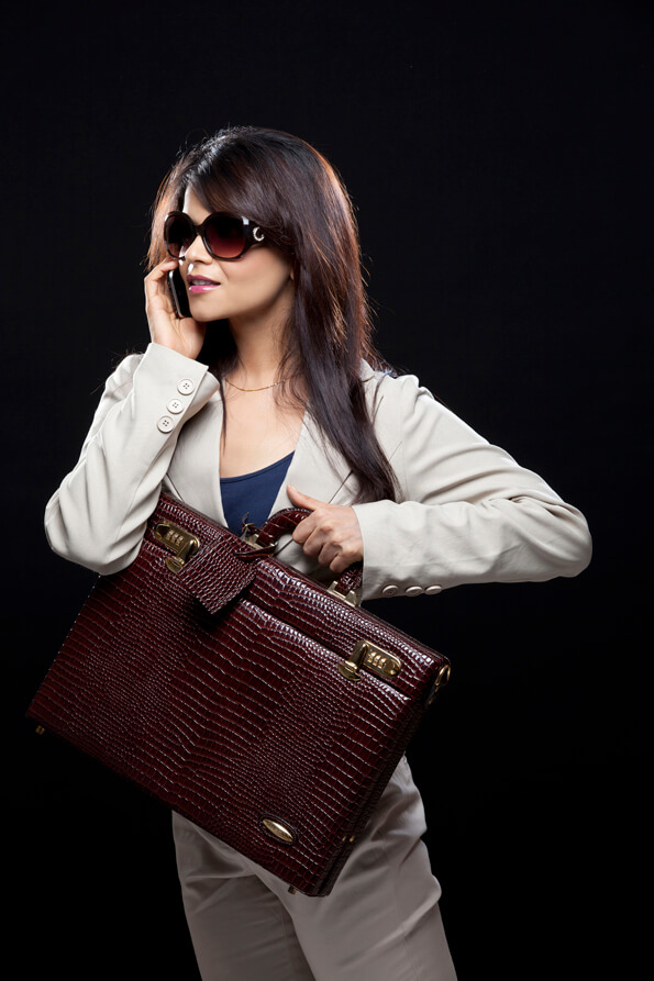 corporate girl carrying her stylish leather briefcase