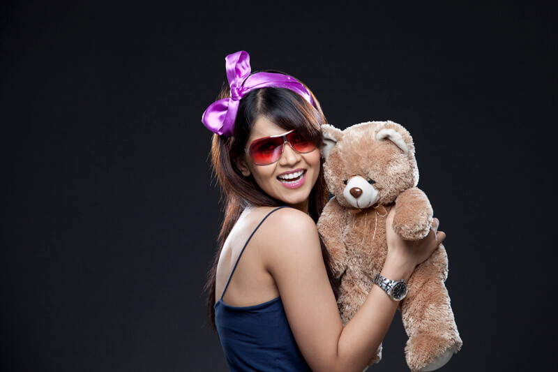 smiling young woman with her teddy bear