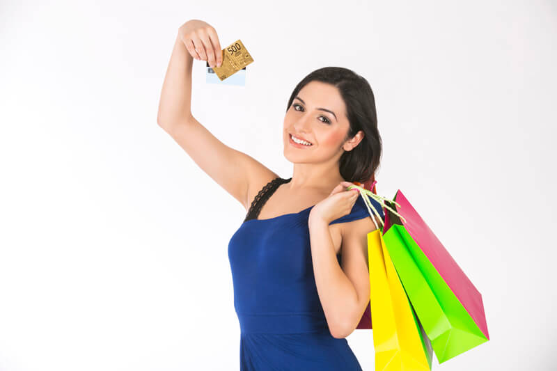 young woman with shopping bags and a credit card
