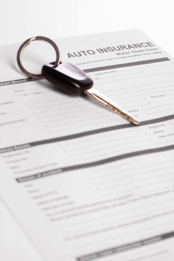 car keys and auto insurance form lying on the table