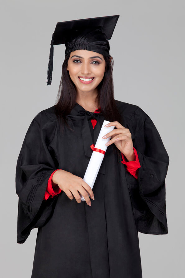 girl posing in graduation gown with degree in hand