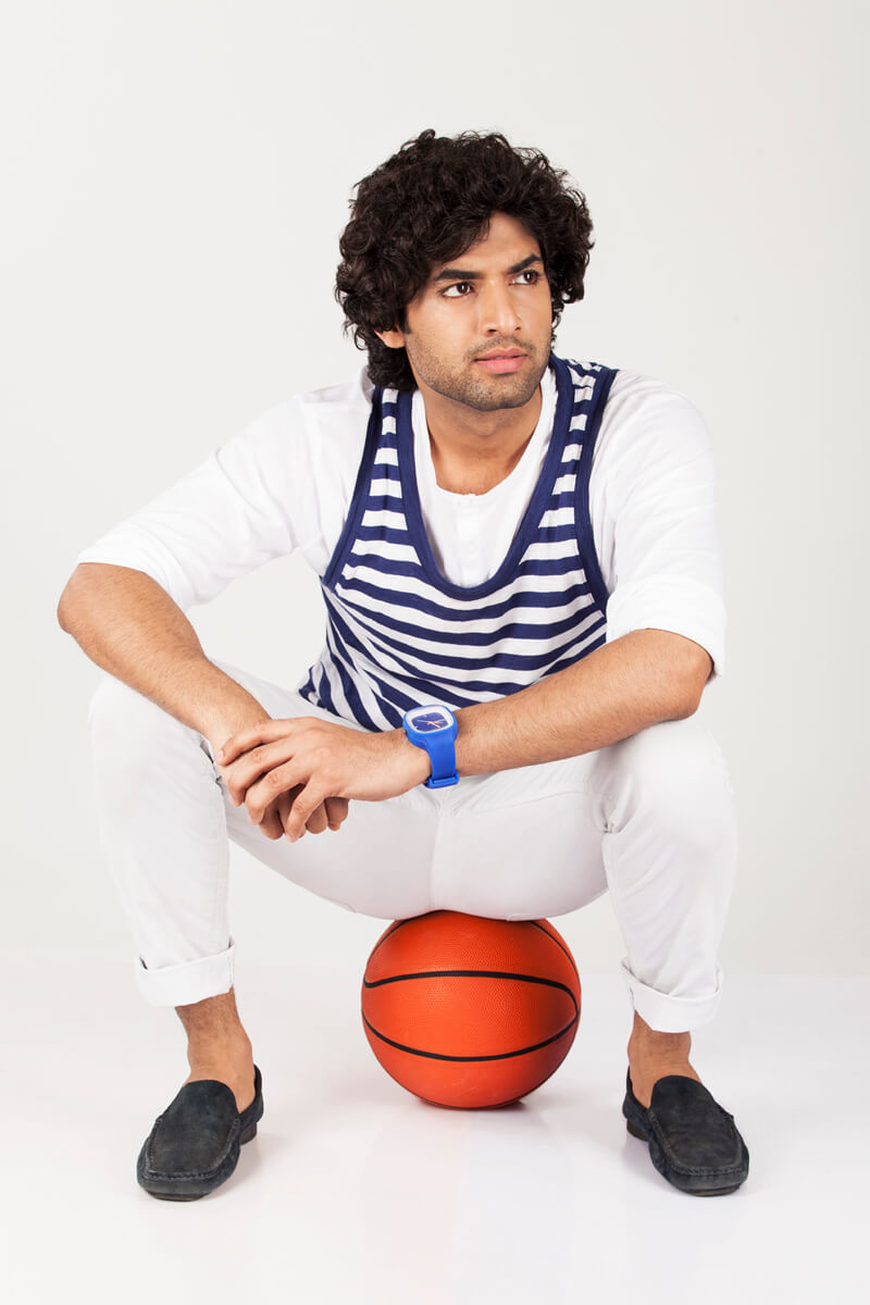 college boy sitting on basketball