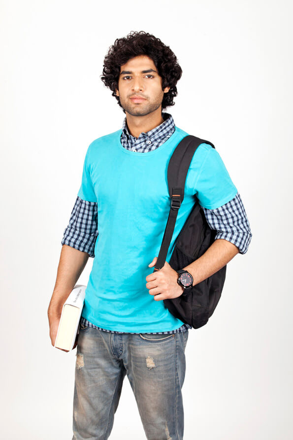 college boy carrying bag and holding book