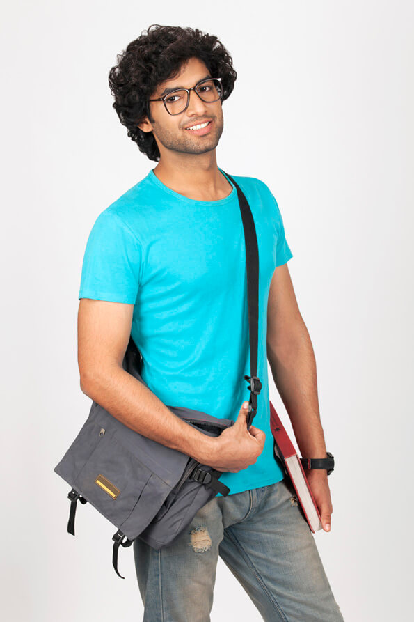 college boy posing while holding his bag 