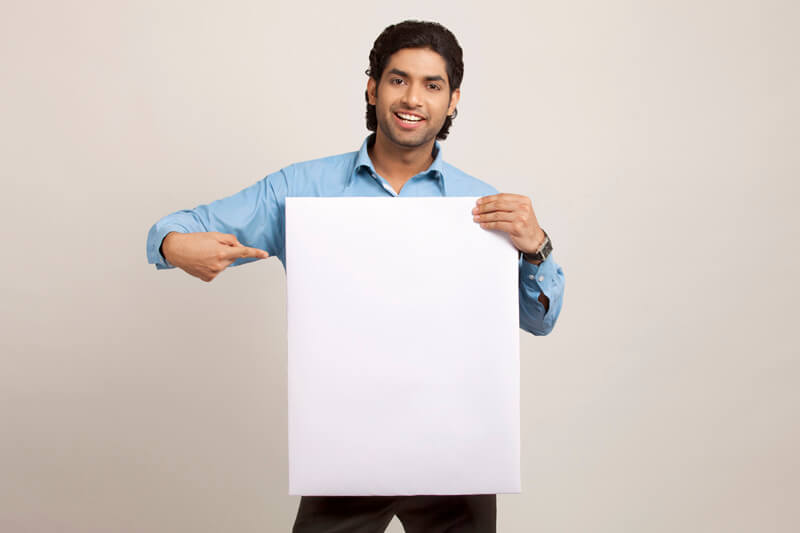 man displaying board while posing