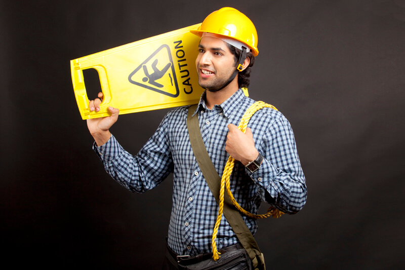 man carrying caution board with rope