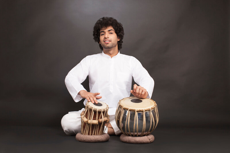 man performing classical music with tabla  