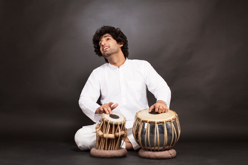 man playing tabla while posing 