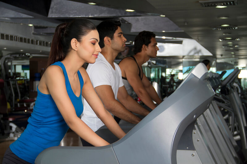 shot of three young people in the treadmill