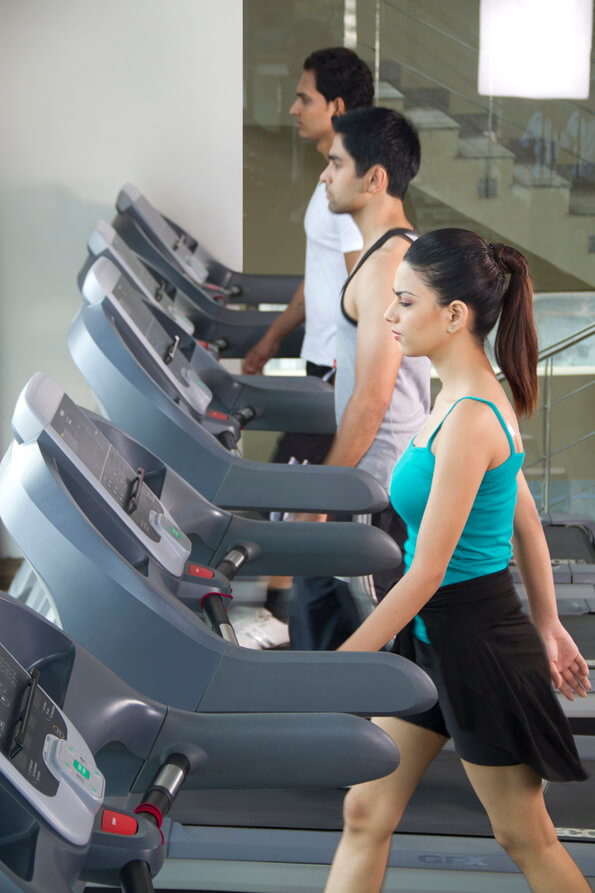 side view of three people at the treadmill 