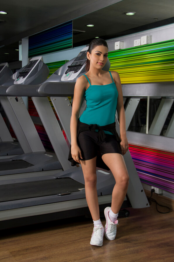 girl leaning against treadmill
