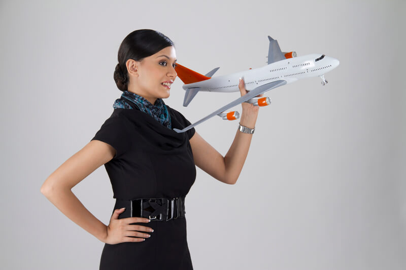 woman posing with an airplane toy