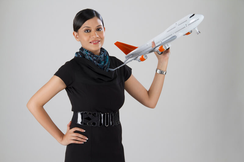 stylish woman with an airplane toy