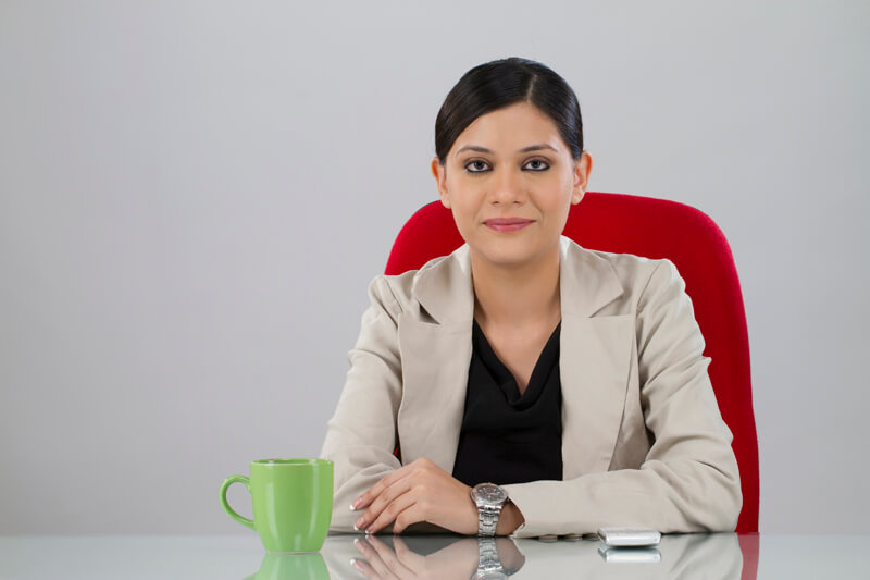 business woman posing at her office desk