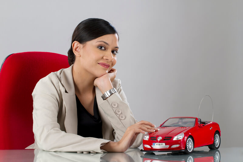business woman with a toy car on her table