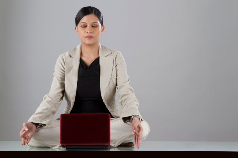 woman meditating while working