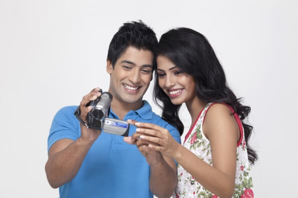 couple looking at video recorder