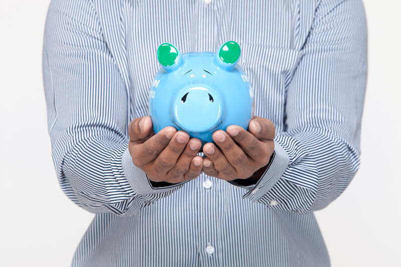 man holding piggy bank against a white background