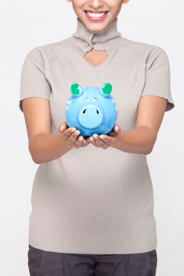 young woman standing with piggy bank