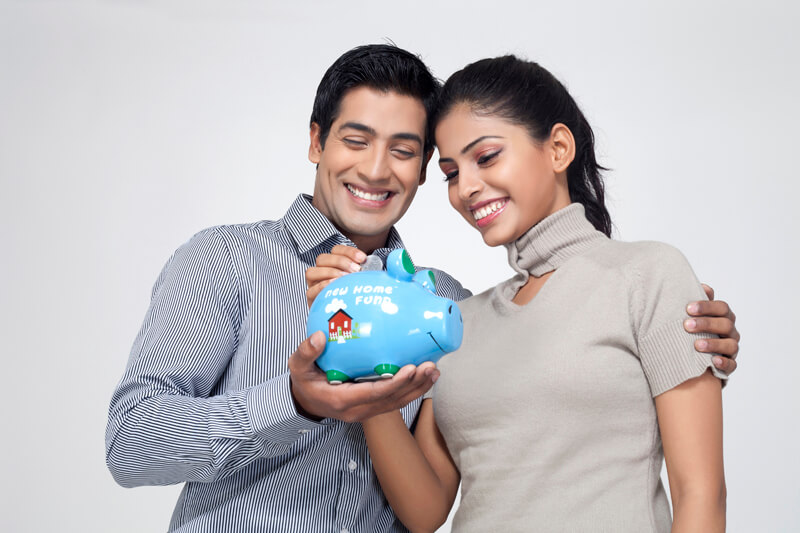 couple holding piggy bank and smiling
