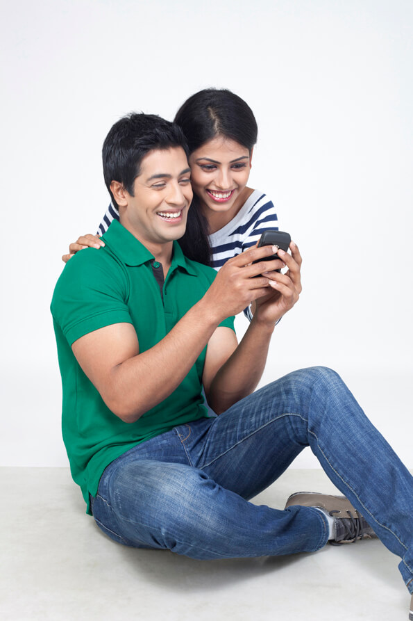 cheerful couple together against a white background