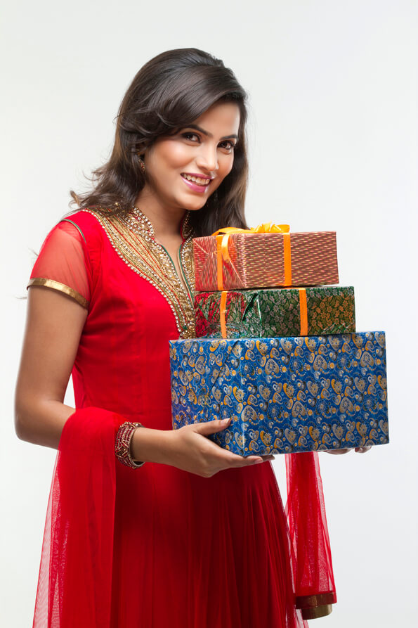 woman holding presents in a side pose