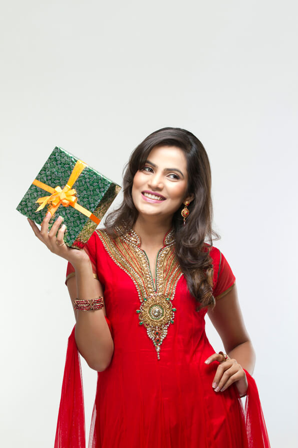 woman posing happily with gift