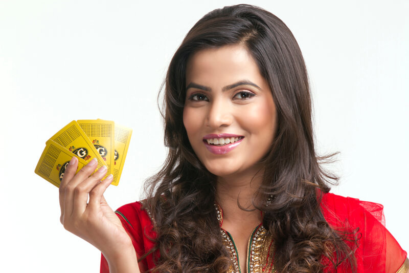 woman smiling and posing with playing cards