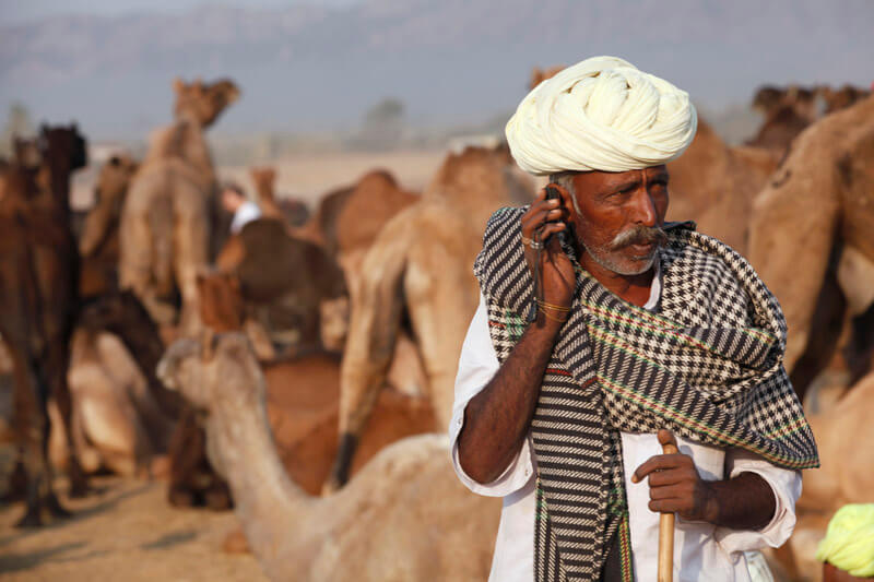rural mean wearing turban talking on phone 