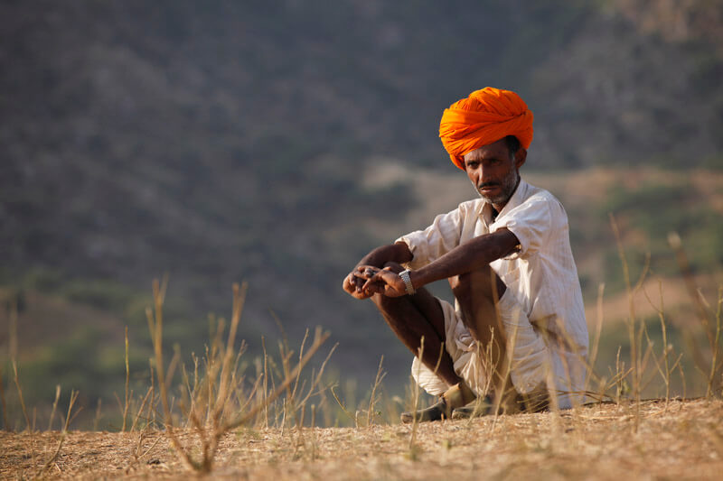 rural man sitting in the field