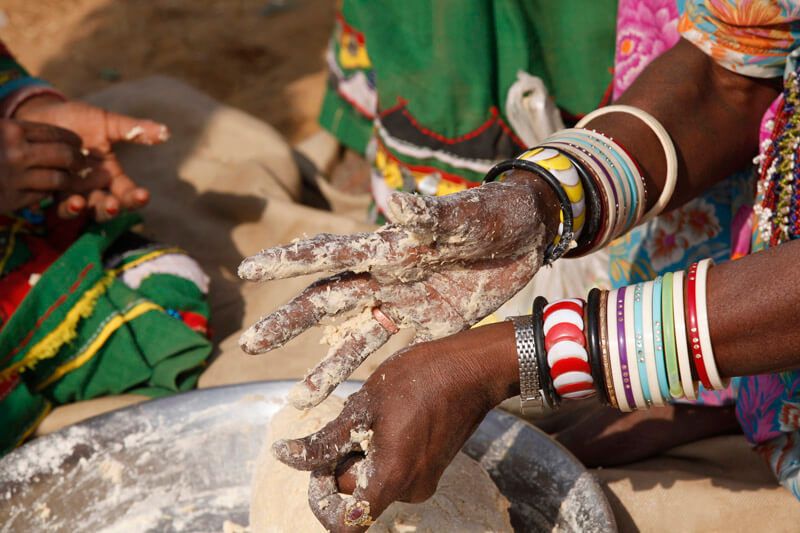 close-up on the hands of a woman making chapatti breads