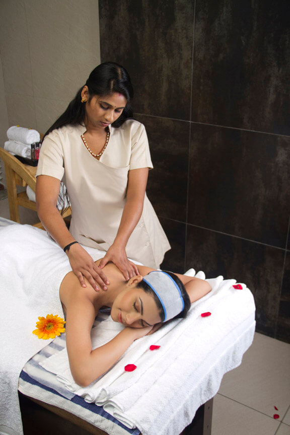 therapist giving body massage