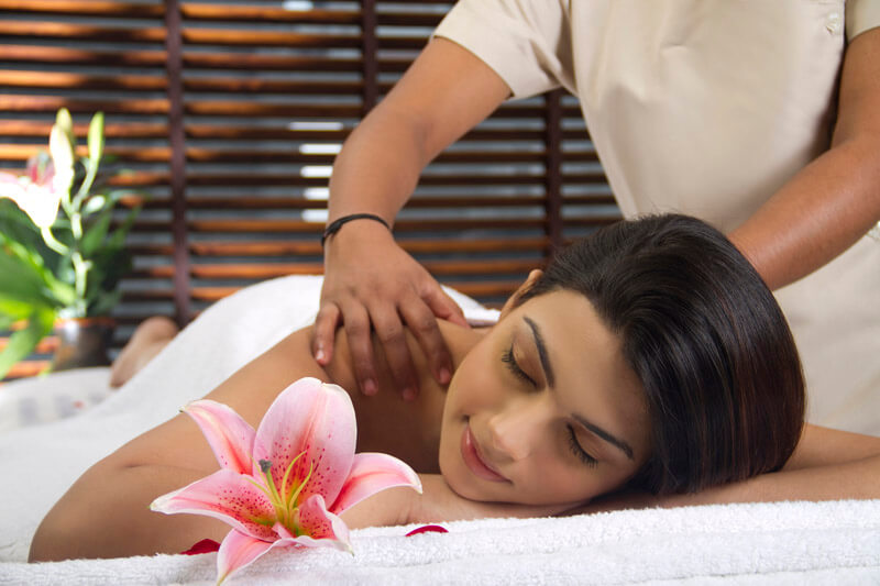 woman taking massage at spa centre