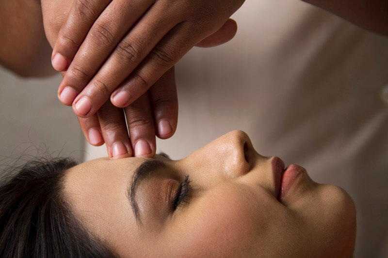 woman taking head massage